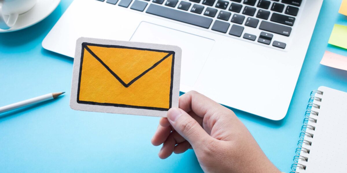 yellow email icon on blue background with laptop